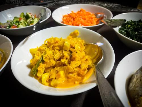 a plate of food with pasta and vegetables on a table at Ella Happy View Homestay in Ella