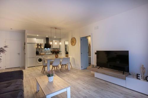 a living room with a large flat screen tv at Huellas de la Mancha in Burguillos de Toledo