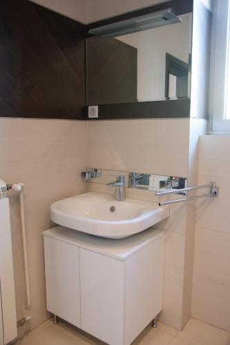 a bathroom with a white sink and a mirror at Square 6 in Belgrade