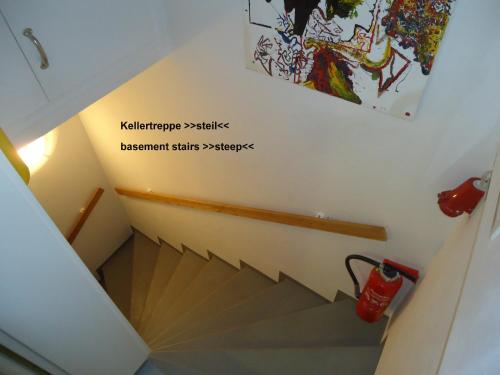 a view of a staircase with a painting on the wall at Gästehaus Sommertal, eigener Parkplatz, 800m zum Bodensee, 300m zur Altstadt in Meersburg
