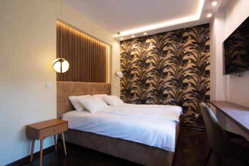 a hotel room with a bed and a wall at Square 6 in Belgrade