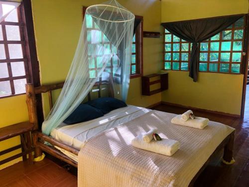a bedroom with a bed with towels on it at GreenPoint Drake Bay in Drake