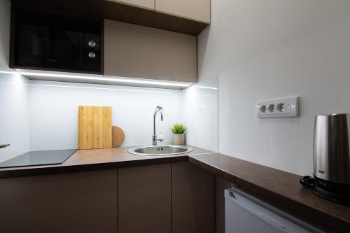 a kitchen with a sink and a microwave at Square 6 in Belgrade
