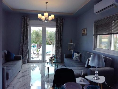 a blue living room with a couch and a table at Villa Casagrande in Kriopigi