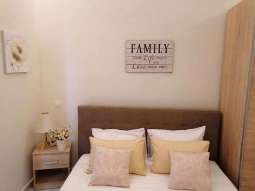 a bedroom with a bed with a family sign on the wall at Villa Casagrande in Kriopigi