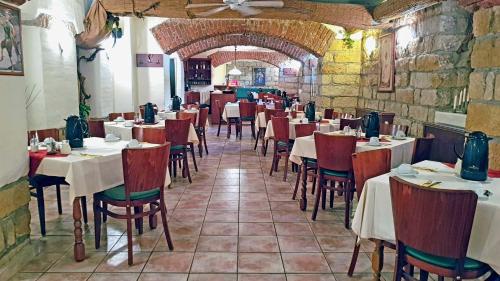 a restaurant with tables and chairs in a room at Hotel Amadeus Dresden Neustadt in Dresden