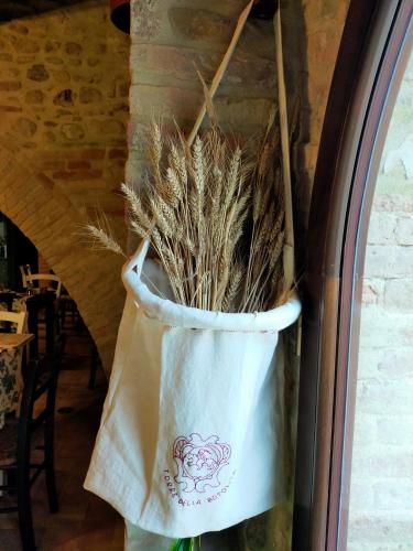 a bag of wheat is hanging on a window at Torre della Botonta in Castel Ritaldi