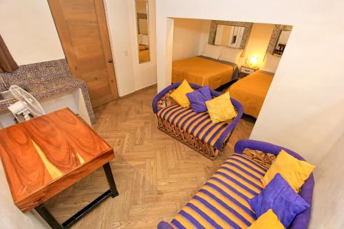 a living room with a couch and a bed and a mirror at El Secreto in San Miguel de Allende