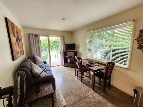 a living room with a couch and a table at Avalon Resort in Kerikeri