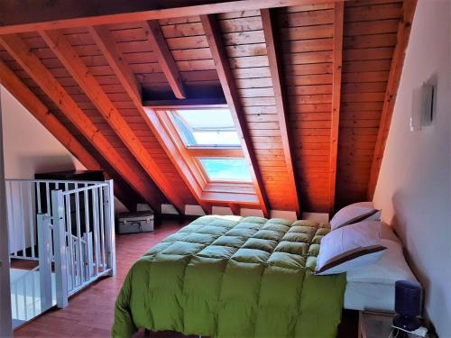 a bedroom with a large bed with a skylight at Beautiful holiday home in Campagnano with private terrace in Musignano
