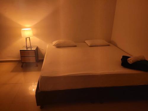 a bedroom with a bed with a lamp on it at BOUTIQUE REAL in Barrancabermeja