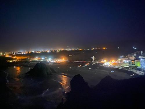a view of a city at night with lights at Goldenbeachhouse in Mirleft