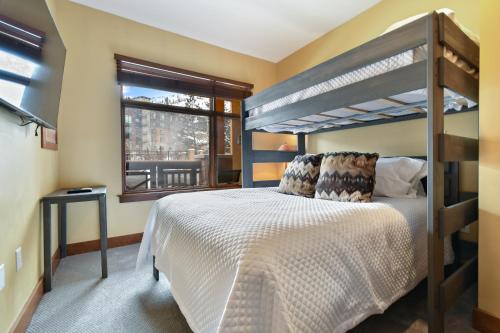 a bedroom with a bunk bed and a window at Ski in Ski Out at Sundial Lodge Walk out to Pool 2BR C006 in Park City