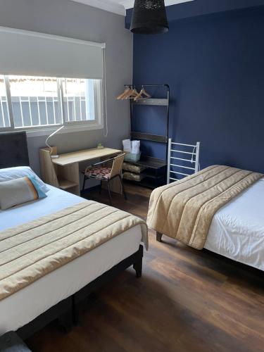 Postel nebo postele na pokoji v ubytování TQCaleta Providencia Barrio Italia