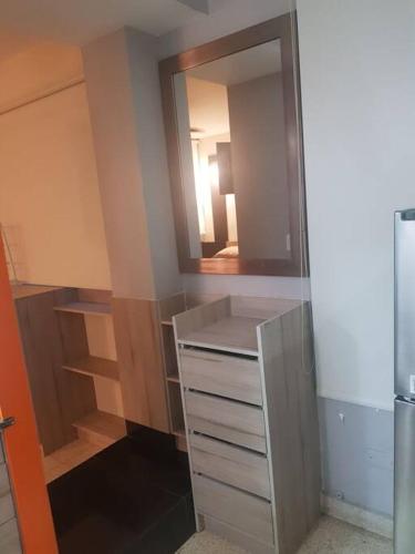 a closet with a mirror and a dresser at R.501 Estudio ejecutivo, en el centro. in Panama City
