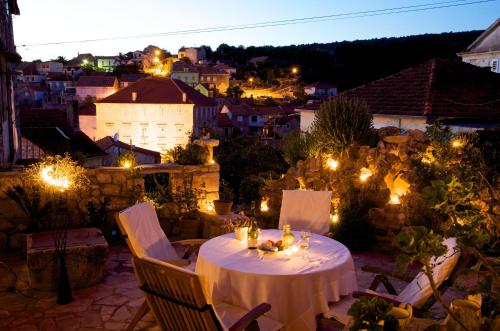 a table and chairs on a patio at night at Villa Moro House in Milna