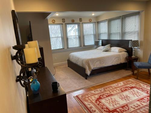 a bedroom with a bed and a room with a rug at Deluxe King Master Suite in Washington