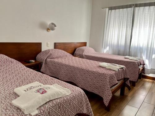 Un ou plusieurs lits dans un hébergement de l'établissement Hotel Lobato