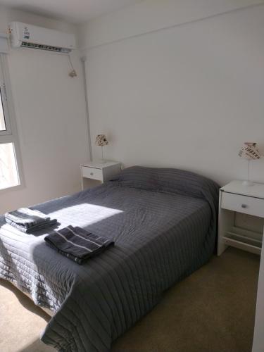 a bedroom with a bed with towels on it at A estrenar Parque del Sur in Santa Fe