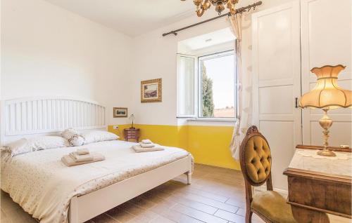 a bedroom with a bed and a desk and a window at Podere Matilde in Montebello