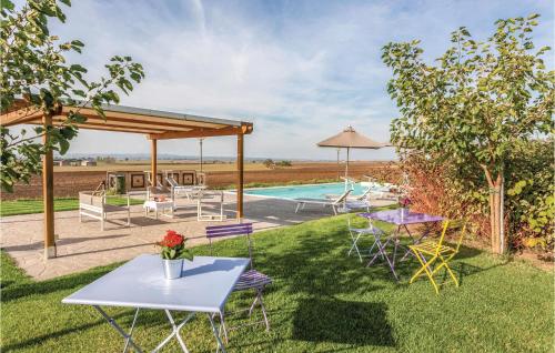 a backyard with a table and chairs and a pool at Podere Matilde in Montebello