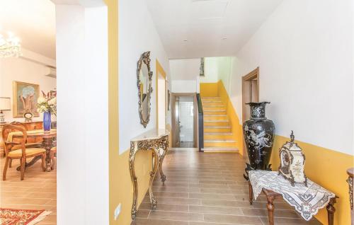 a hallway with a staircase and a living room at Podere Matilde in Montebello