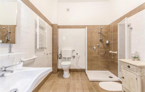 a bathroom with a toilet and a sink and a shower at Podere Matilde in Montebello