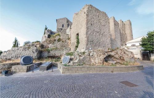 a large stone building with two benches in front of it at Podere Matilde in Montebello