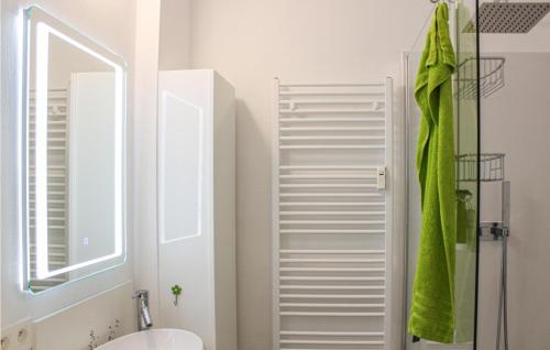 W białej łazience znajduje się umywalka i lustro. w obiekcie Residentie Chopin w Ostendzie