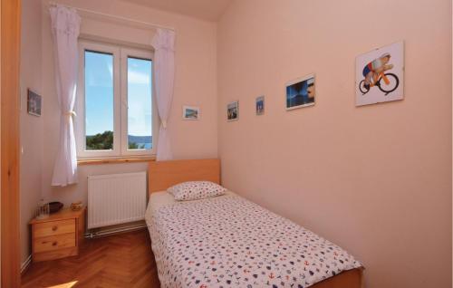 a small bedroom with a bed and a window at 3 Bedroom Nice Apartment In Split in Split