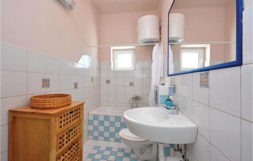a bathroom with a sink and a toilet and a mirror at 3 Bedroom Nice Apartment In Split in Split