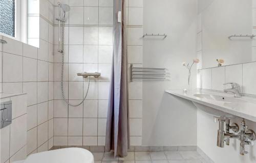a bathroom with a shower and a toilet and a sink at Amazing Apartment In Allinge in Allinge