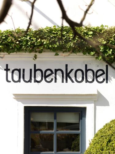 a sign on top of a building at Relais & Châteaux Taubenkobel in Schützen am Gebirge