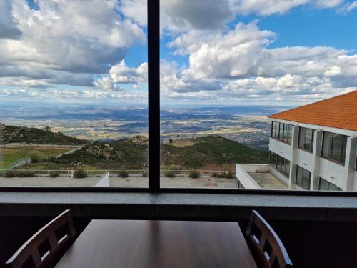 a view of the city from a window of a building at Hotel Albergaria Senhora do Espinheiro in Seia