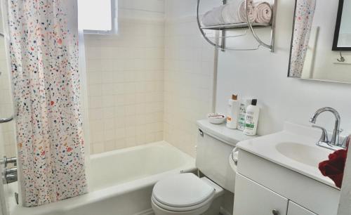 a white bathroom with a toilet and a sink at University Home-near U Of U, Hospitals, Downtown in Salt Lake City