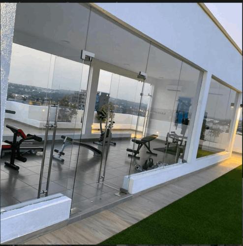 a glass office with a view of the city at The Moonlight Manor Suite in Accra