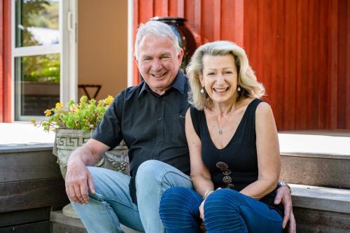 a man and a woman sitting on steps at Criffel Bluffs Cottage in Wanaka