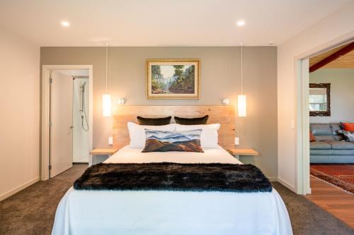 a bedroom with a large white bed in a room at Criffel Bluffs Cottage in Wanaka