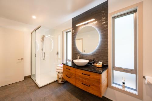 a bathroom with a sink and a mirror at Criffel Bluffs Cottage in Wanaka