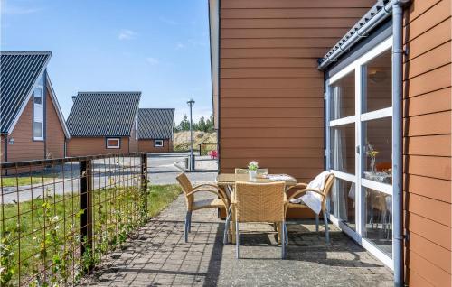 a patio with a table and chairs next to a house at Lovely Home In Hadsund With Wifi in Hadsund