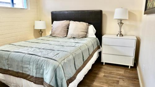 a bedroom with a bed and a nightstand with two lamps at University Retreat-near U Of U, Hospital,downtown in Salt Lake City