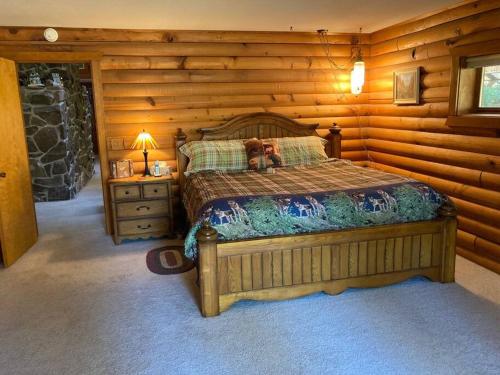 a bedroom with a bed with a teddy bear on it at Hummingbird Hill Resort: Hot Tub, Views, Wildlife, 3D movies, Hiking, Bikes, Sleds, Games, Kids & Pets Love It in Naches