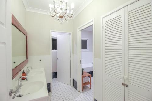 a bathroom with a sink and a mirror at Bundeena Base Art House in Bundeena