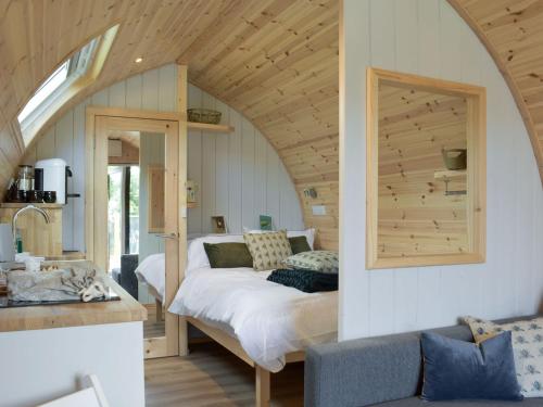 a bedroom with a bed in an attic at Pentland Pod in Penicuik