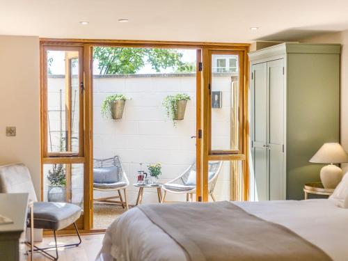 a bedroom with a bed and a patio at The Old Workshop in Broom