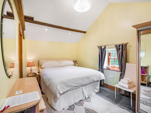 a bedroom with a bed and a mirror at Corby Castle - Diamond Cottage - Uk34668 in Great Corby