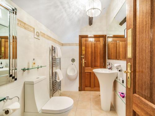 a bathroom with a sink and a toilet and a mirror at Corby Castle - Diamond Cottage - Uk34668 in Great Corby