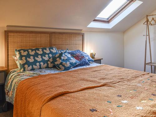 a bedroom with a large bed and a skylight at Warrington House in Tideswell