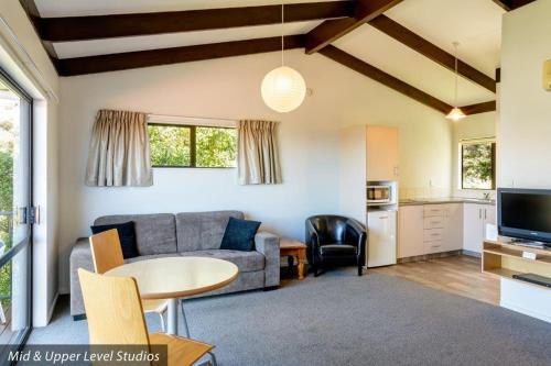 a living room with a couch and a table at Unit 5 Kaiteri Apartments and Holiday Homes in Kaiteriteri