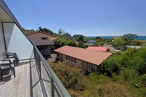 a balcony with a view of a house at Unit 5 Kaiteri Apartments and Holiday Homes in Kaiteriteri